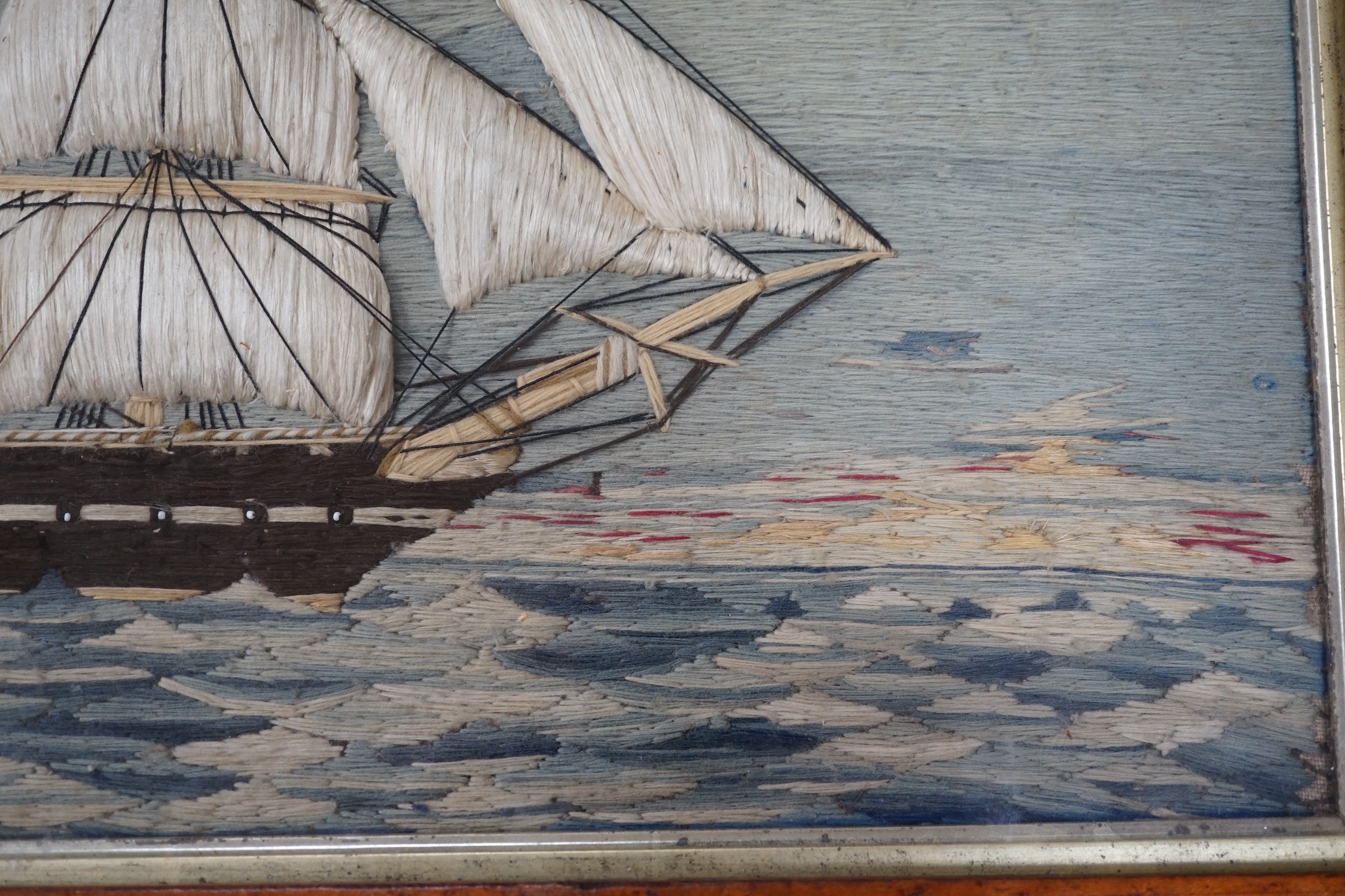 A maple framed 19th century wool work embroidery of a steam ship of the English fleet, 63cms wide, 47cms high